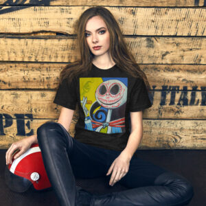 Young woman seated against a weathered wooden wall, wearing a black graphic T-shirt and holding a red-and-white helmet near her leg.